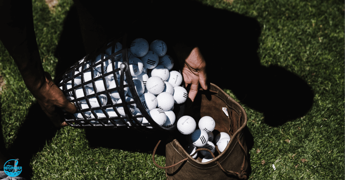 A man putting some golf balls in the bucket.