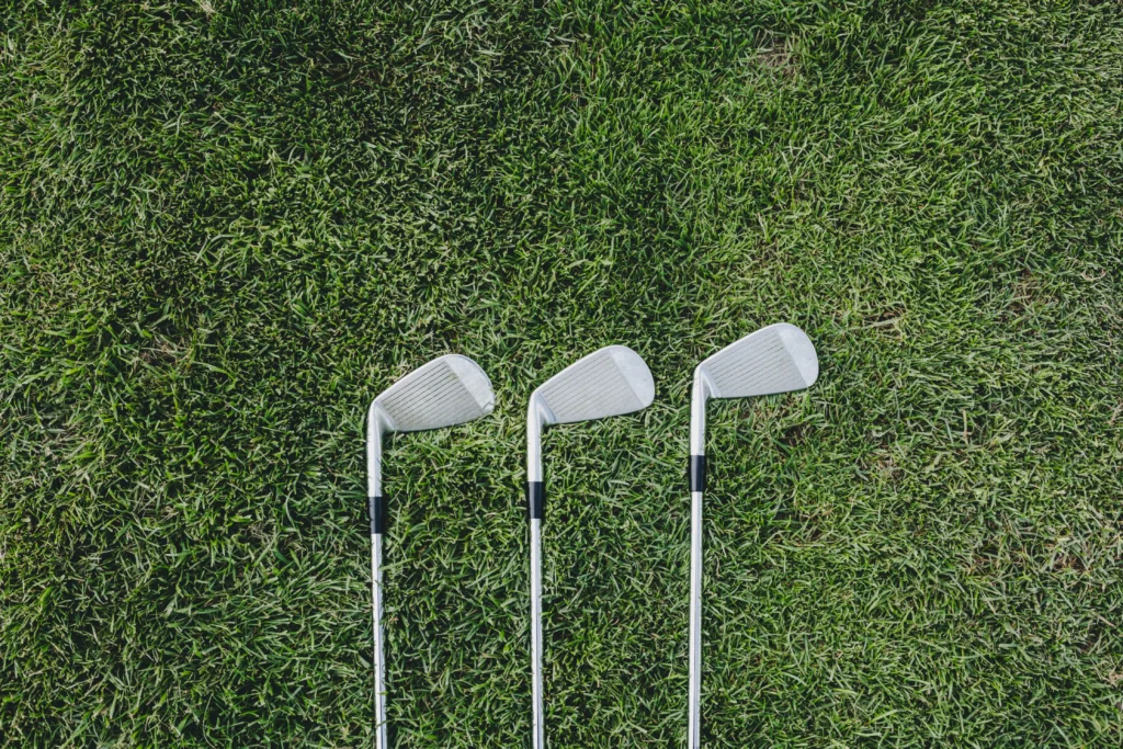 Three golf clubs on the green